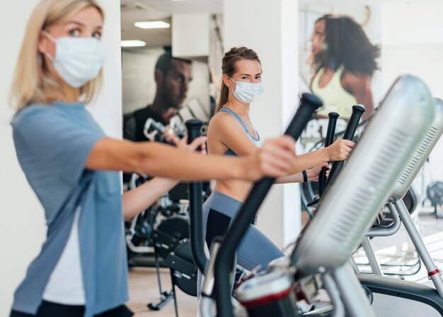 Women exercising at the gym with mask