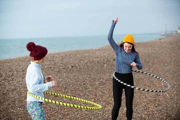 Free photo women exercising with hula hoop circle