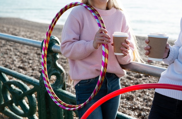 Free photo women exercising with hula hoop circle