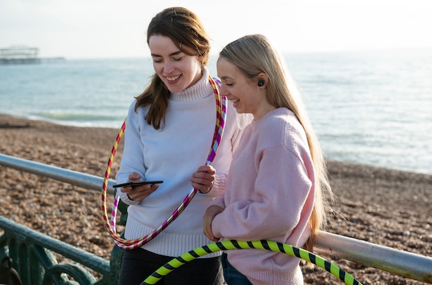 Free photo women exercising with hula hoop circle