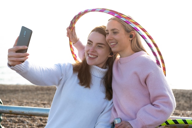 Free Photo women exercising with hula hoop circle