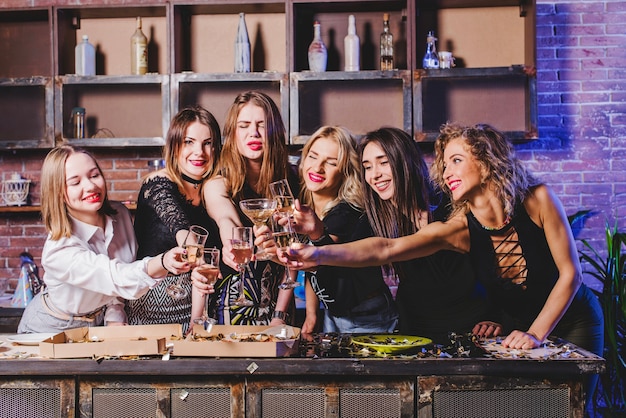 Women friends clinking glasses