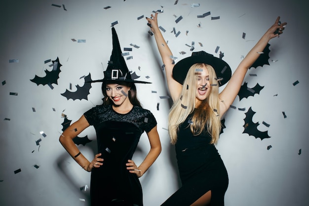 Women in Halloween hats in confetti