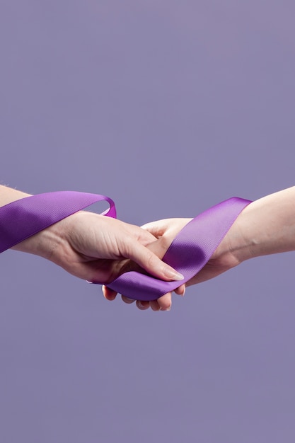 Free photo women hands holding ribbon with copy space