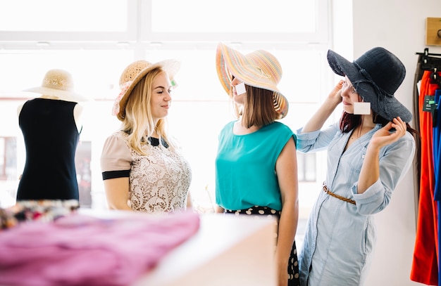 Free photo women in hats looking at each other