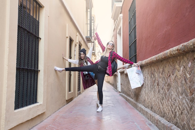 Women having fun on narrow street