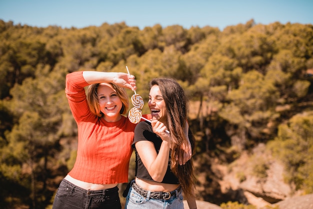 Free photo women having fun with lollipops