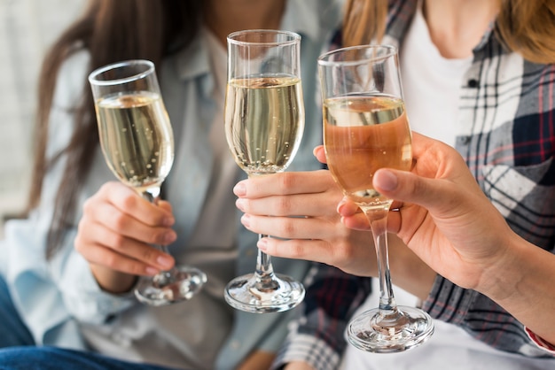 Women holding champagne glasses for toast