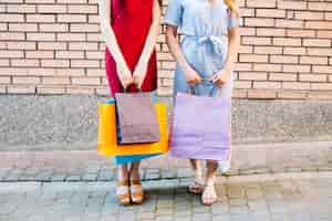 Free photo women holding paper bags