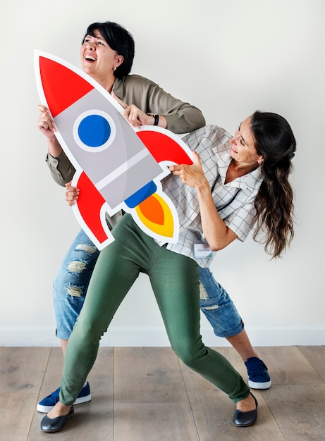 Free photo women holding rocket icon