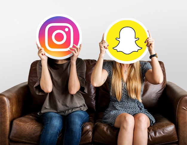 Free Photo women holding social media icons