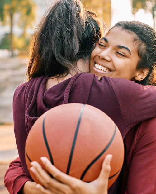 Women hugging after a basketball game