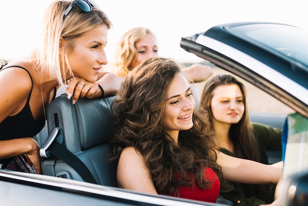 Women looking at map in cabriolet 