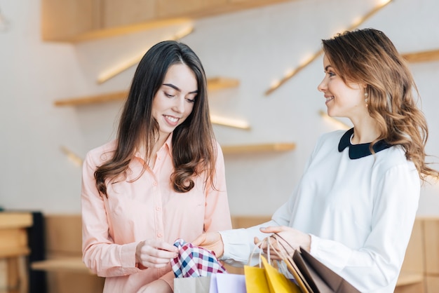 Free Photo women looking at purchases