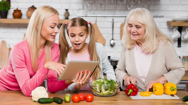 Women looking at the tablet in the kitchen