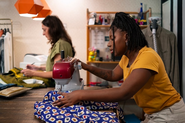 Women modifying clothing in thrift store