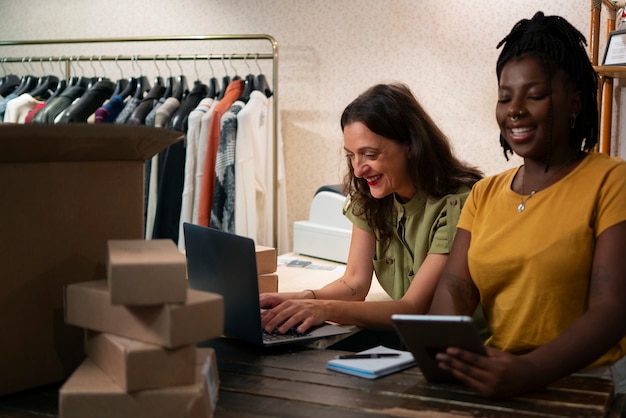 Women packaging clothing in thrift store