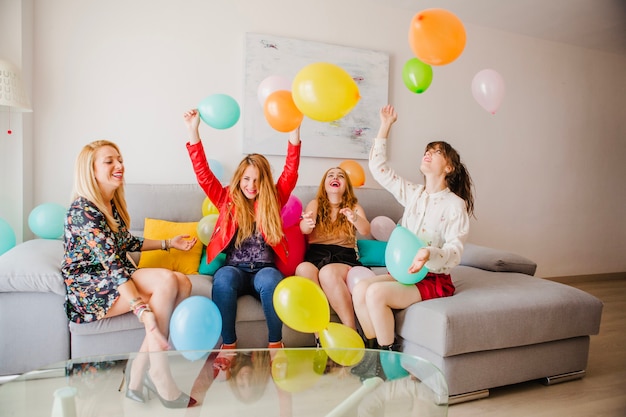 Free photo women playing with balloons