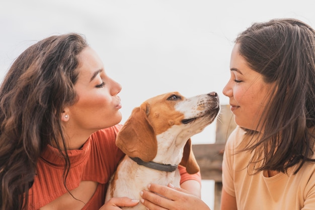 Women playing with dog