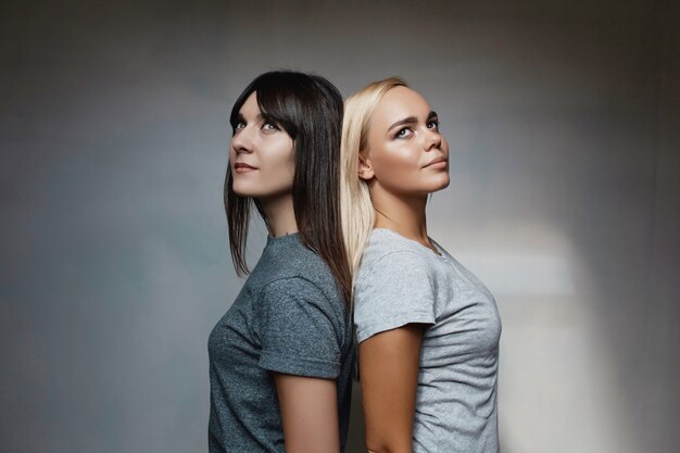 Women posing on wall