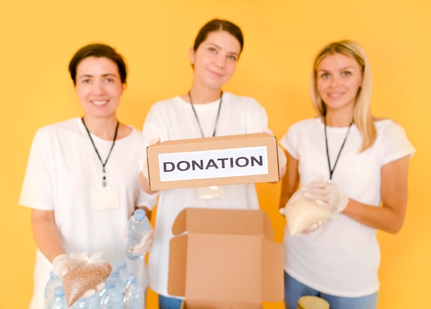 Free Photo women preparing boxes with food to donate