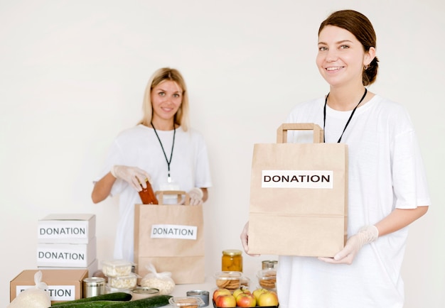 Free photo women preparing charity bags for donation