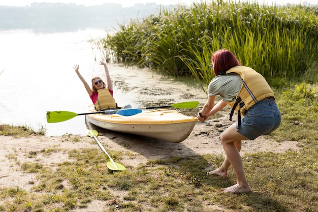 Women pushing kayak intro water