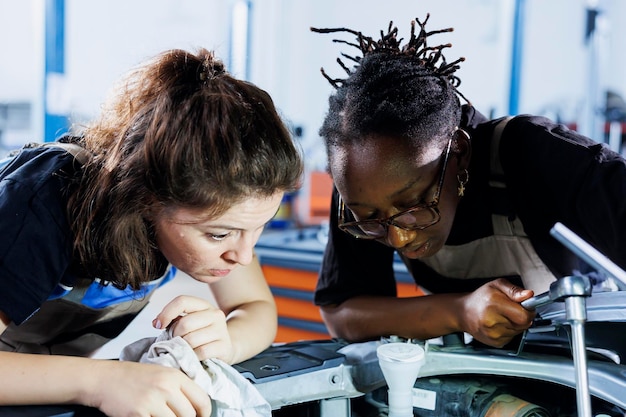 Free Photo women in repair shop fixing vehicle