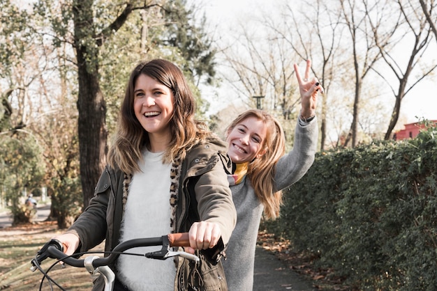 Free Photo women riding bike in park