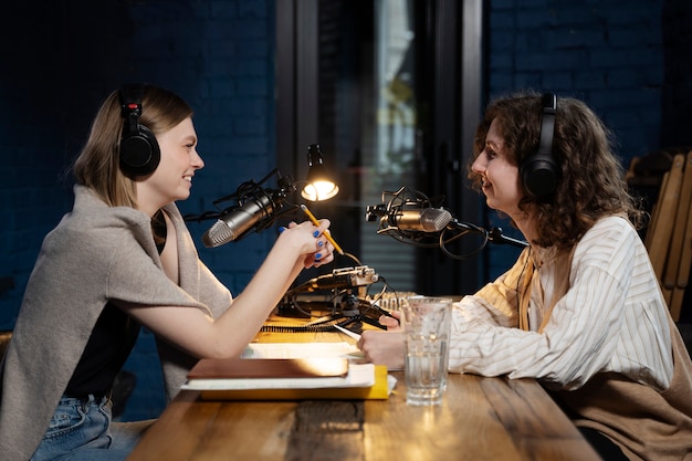 Free Photo women running a podcast while wearing headphones