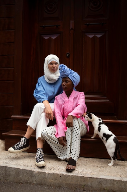 Women sitting on stairs with cat side view