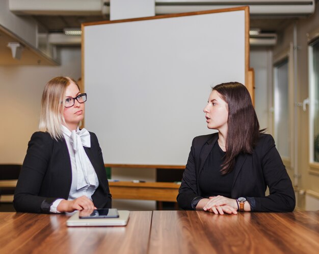 Women sitting at table talking