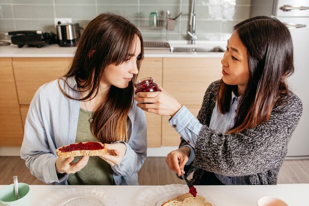 Women smelling tasty jam