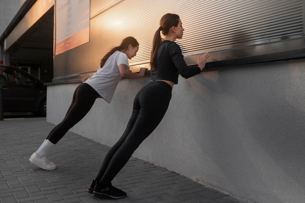 Women stretching together before working out outdoors