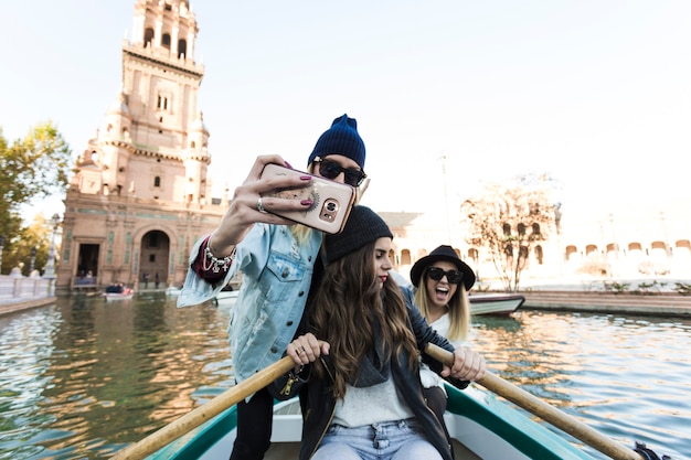 Women taking selfie on boat