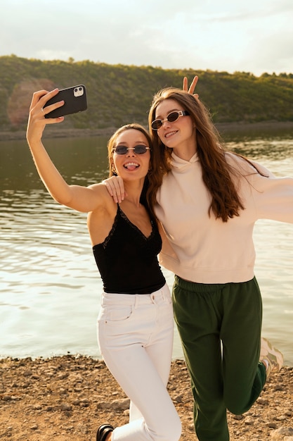 Free Photo women taking selfie front view