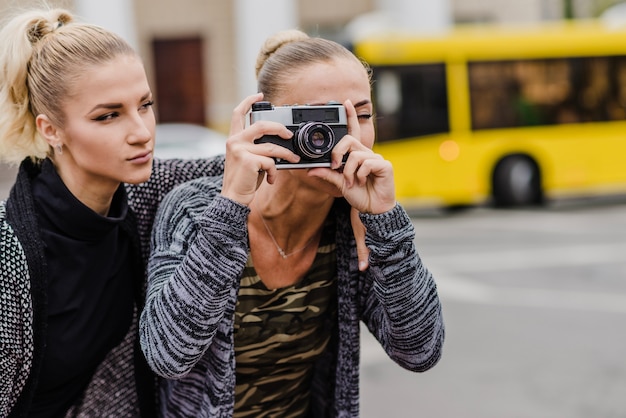 Free photo women taking shots in city