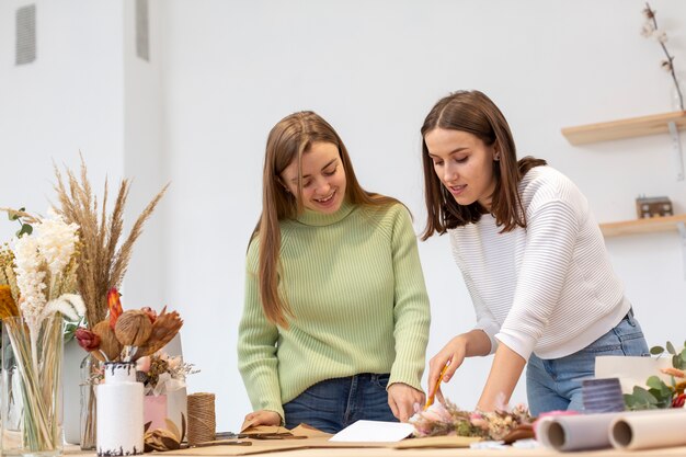 Women in their flower shop being focused