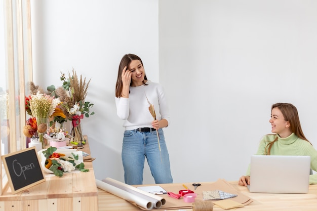 Women in their flower shop being happy