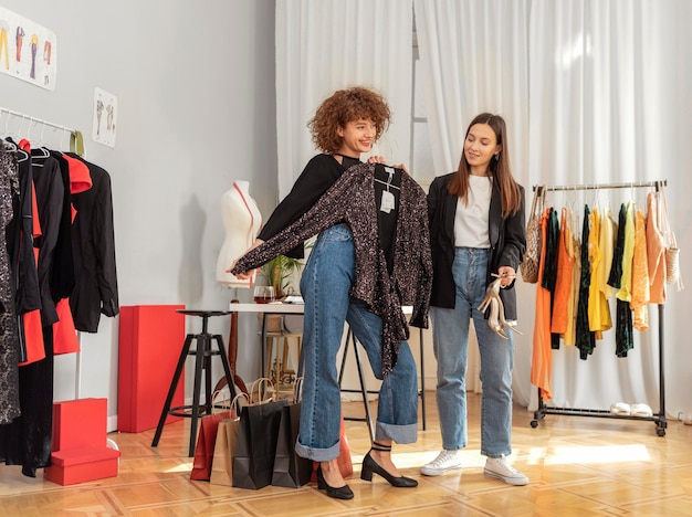 Women trying clothes in store