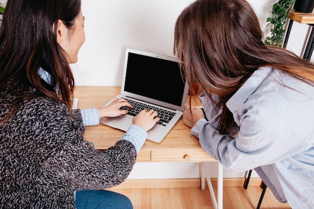 Women typing at laptop