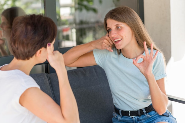 Women using sign language to converse with each other