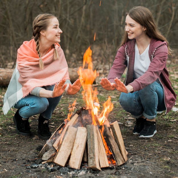 Free Photo women warming at bonfire