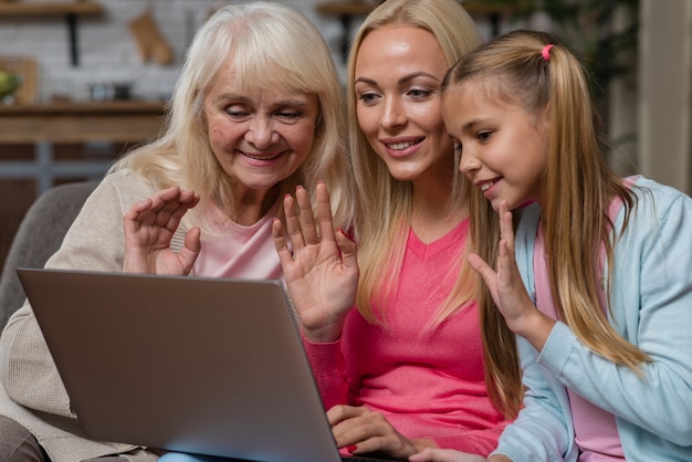 Women waving in front of a laptop