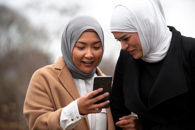 Free Photo women wearing hijab an having a good time