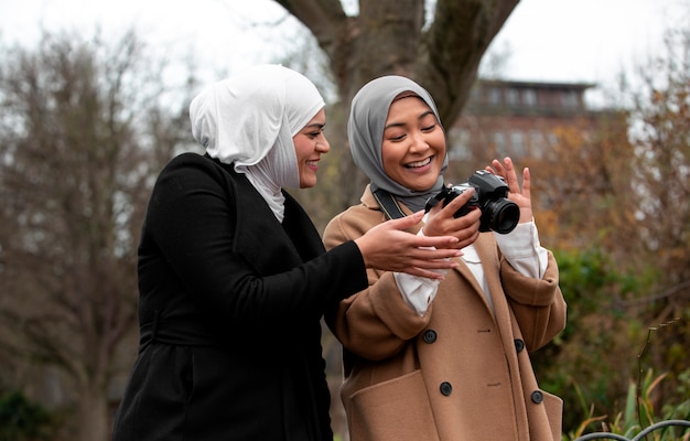 Free photo women wearing hijab an having a good time