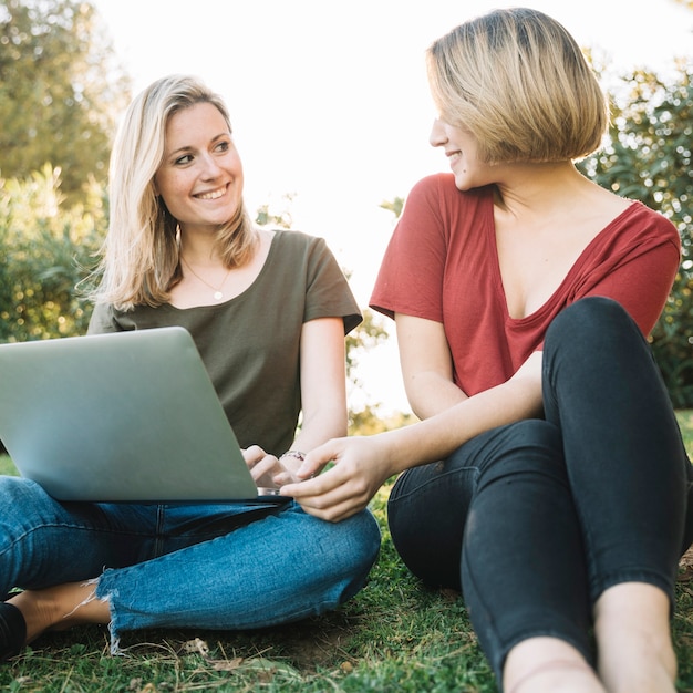 Women with laptop looking at each other