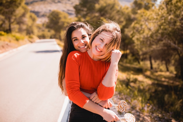 Free photo women with lollipops hugging