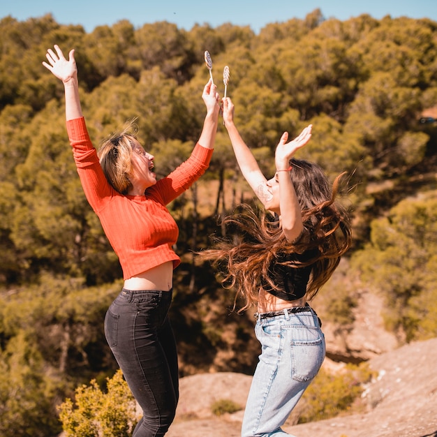 Free photo women with lollipops jumping