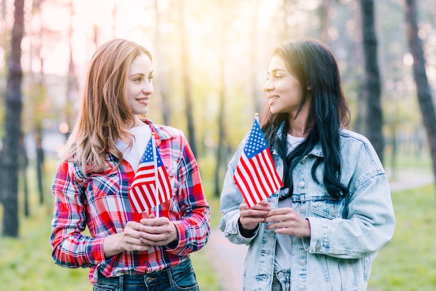 Free Photo women with small american flags standing outdoors